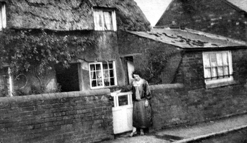 One of the small thatched cottages in Middle Turn, Spratton, which stood where the Millennium Garden is now. The Goodwin family lived here in 1911